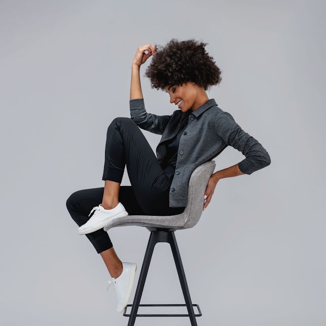 Woman sitting on minimalist-designed chair
