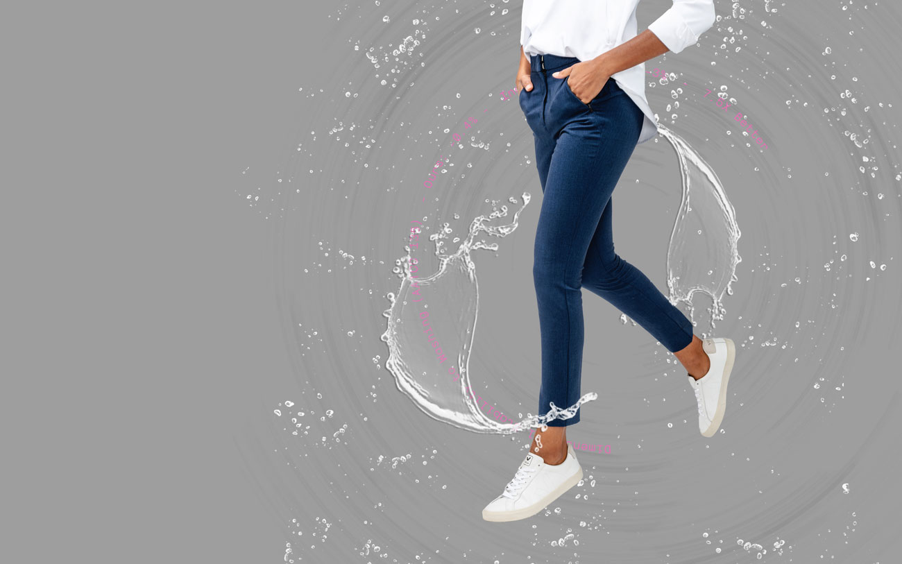 model wearing women's velocity tapered pant surrounded by splashing water