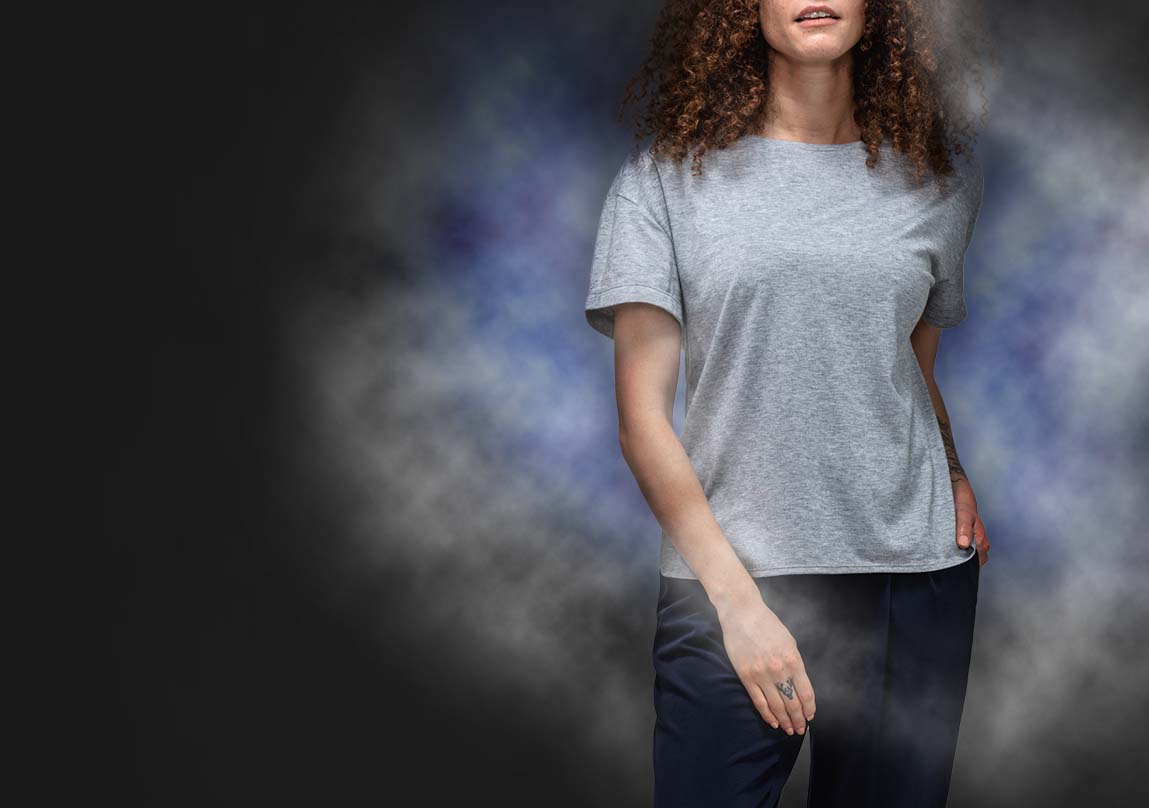 model wearing composite merino boxy tee in front of a cloud of vapor