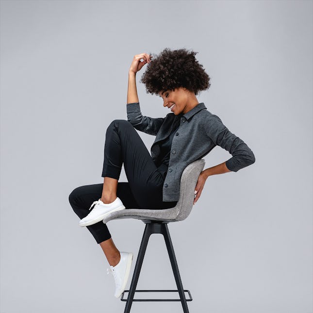 model sitting in chair