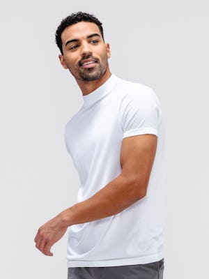 model wearing white atlas high crew tee facing forward with arm in front