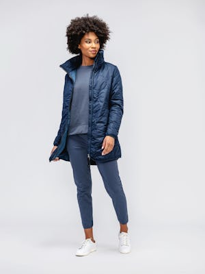 model wearing women's navy aurora insulated jacket and slate blue kinetic pull on pant and navy fusion terry sweatshirt facing forward with jacket unzipped
