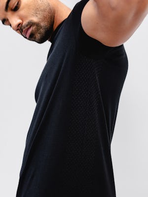 close up of model wearing black atlas high crew tee with arms up to show ventilation