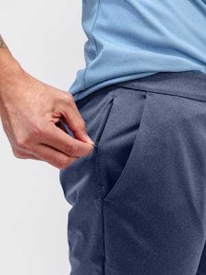 Close up of Men's Slate Blue Kinetic Jogger on model zipping pocket
