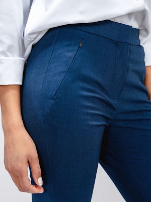 Close up of zippered pocket on women's indigo heather Velocity Tapered pant