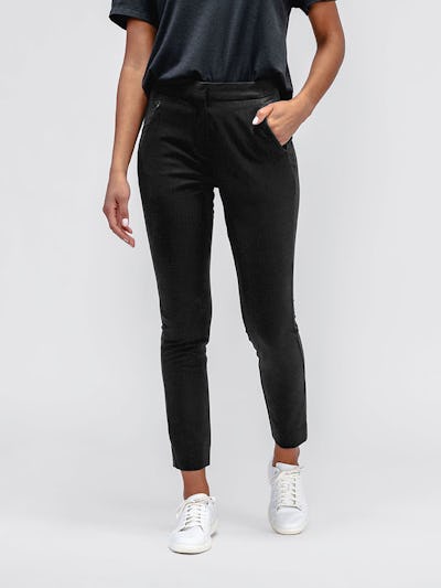 Close up of Women's Black Velocity Tapered Pant on model with hand in pocket