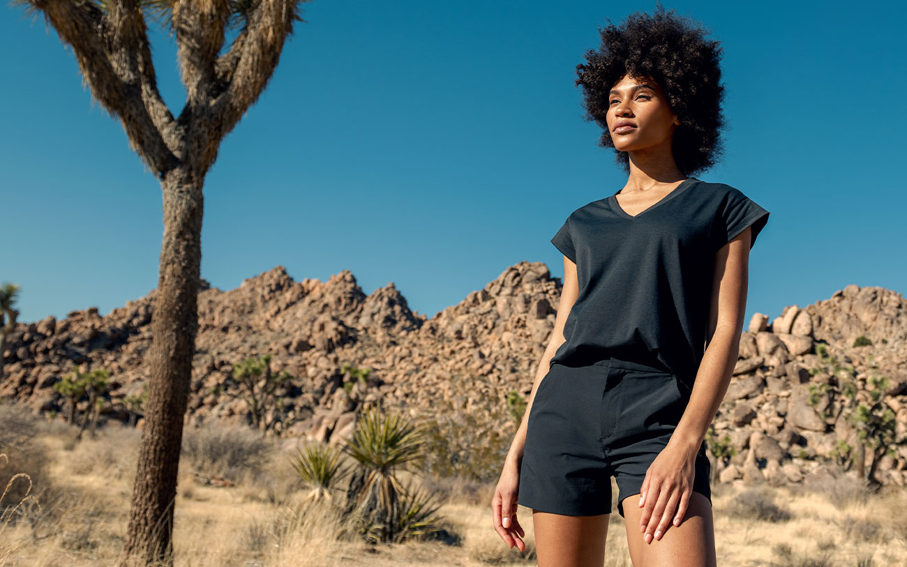 model wearing women's composite merino v-neck tee and pace poplin short in the desert