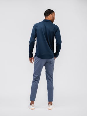 model wearing mens apollo raglan shirt navy and mens kinetic jogger slate blue back shot