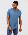 model wearing men's composite merino tee stone blue and mens kinetic jogger slate blue and pulling shirt