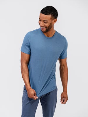 model wearing men's composite merino tee stone blue and mens kinetic jogger slate blue and pulling shirt