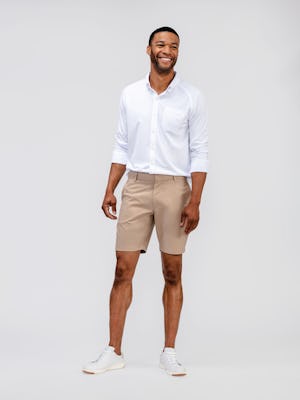 model wearing mens british tan pace poplin shorts and mens apollo shirt white full body front shot