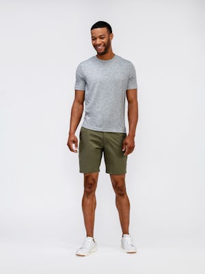 model wearing mens composite merino tee pale grey heather and mens pace poplin shorts olive standing full body shot