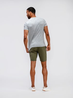model wearing mens composite merino tee pale grey heather and mens pace poplin shorts olive back full body shot