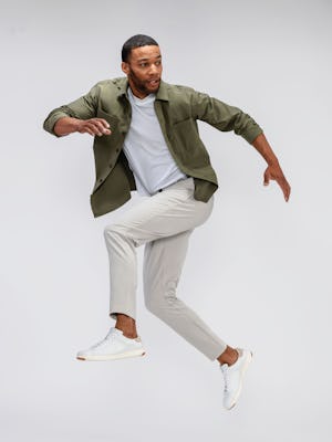 mens pace tapered chino light khaki and mens pace poplin overshirt olive on model jumping 
