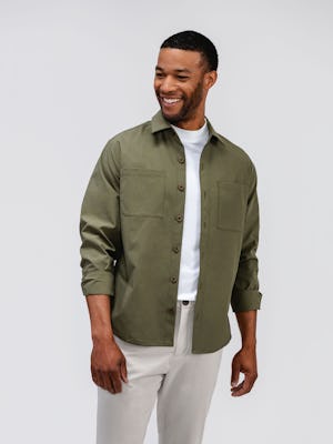 mens pace poplin overshirt olive and mens pace tapered chino light khaki on model standing looking sideways 