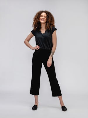 model wearing Black Women's Velocity Pull-On Pant standing with hand on waist
