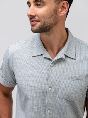 model wearing Men's Grey Tonal Stripe Hybrid Seersucker Short Sleeve Shirt zoomed shot of chest pocket