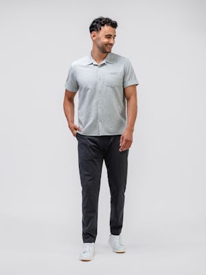 model wearing Men's Grey Tonal Stripe Hybrid Seersucker Short Sleeve Shirt and slate grey kinetic jogger facing forward with hand in pocket