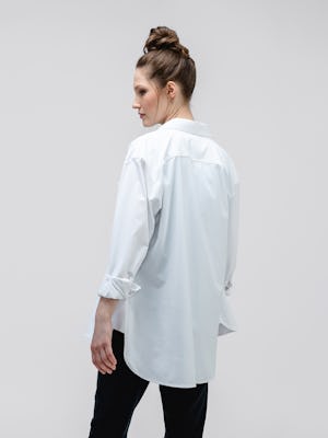 model wearing white aero zero oversized shirt and black fusion terry jogger facing away with sleeves rolled