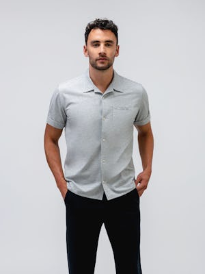 model wearing Men's Grey Tonal Stripe Hybrid Seersucker Short Sleeve Shirt and slate grey kinetic jogger facing forward one hand in pocket