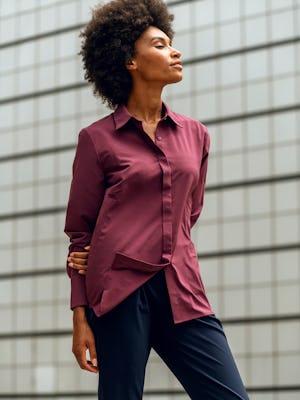 women's deep garnet juno blouse model facing to the side arms behind back