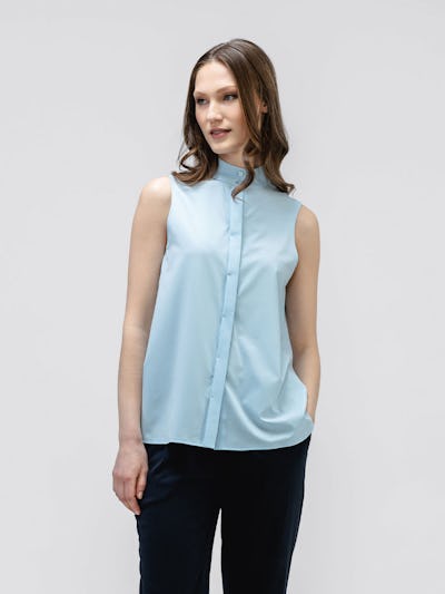model wearing women's chambray blue juno mock neck tank facing forward with hand in pocket