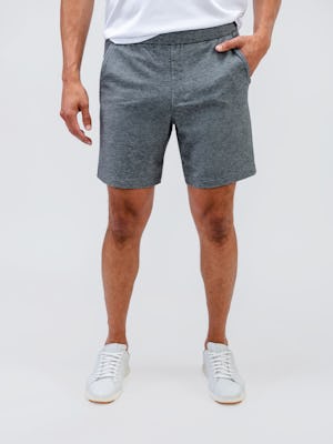 model wearing men's classic grey heather fusion terry short and white apollo polo facing forward with hand in pocket