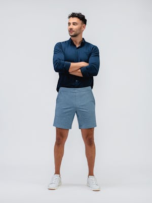 model wearing men's lunar blue fusion terry short and navy apollo raglan sport shirt full body hands crossed
