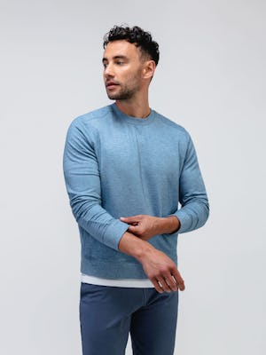 model wearing men's lunar blue fusion terry sweatshirt and slate blue kinetic jogger facing forward with sleeves pulled up