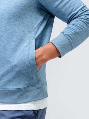 model wearing men's lunar blue fusion terry sweatshirt hand in pocket zoomed in