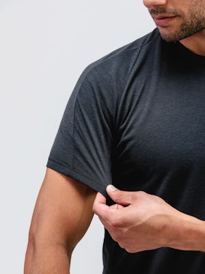 model wearing black composite merino active tee close up of stretching sleeve