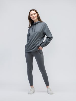 model wearing women joule active legging charcoal and terry for all hoodie classic grey heather standing one hand in leggings pocket