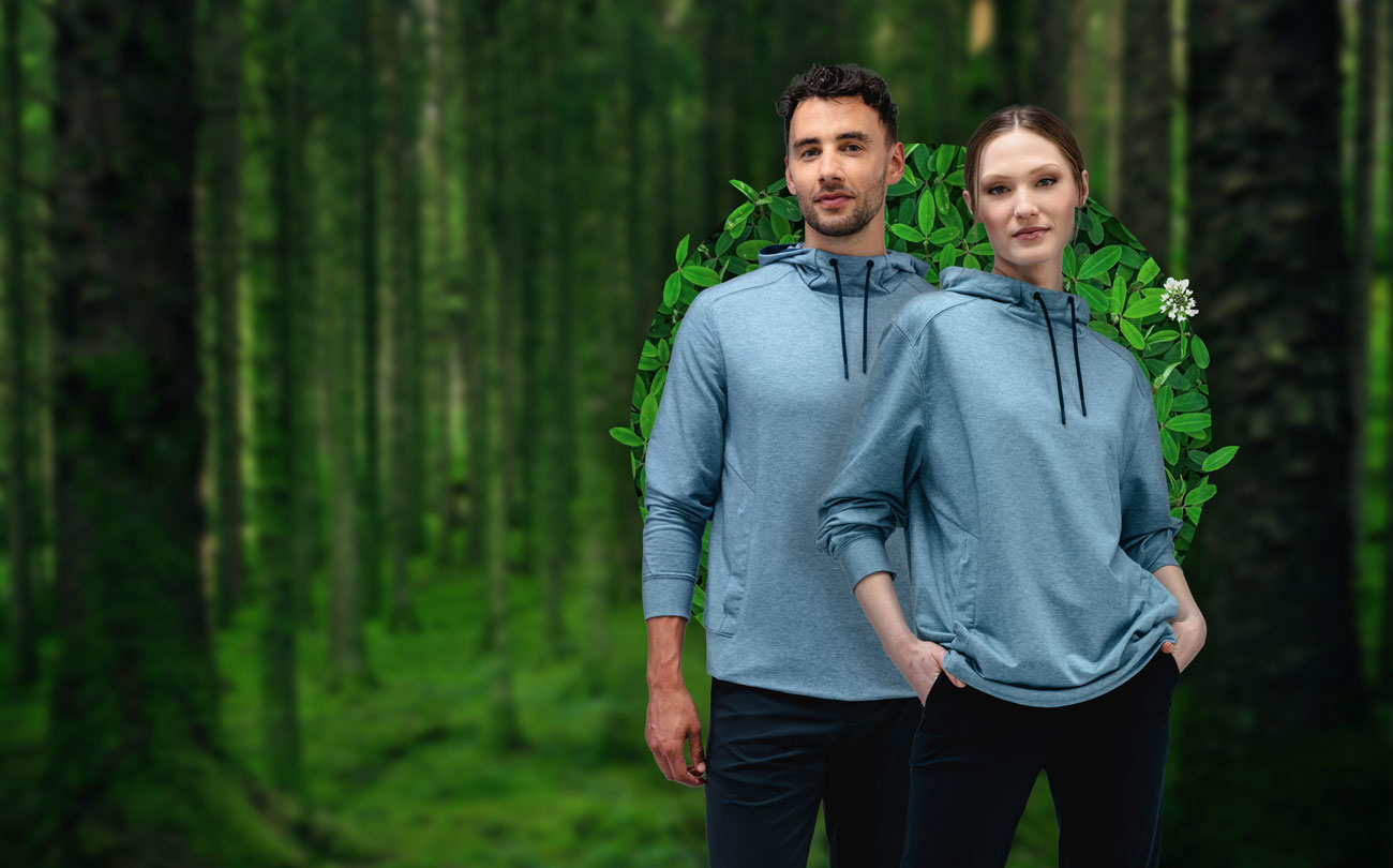 male and female models wearing fusion terry for all hoodies in the forest