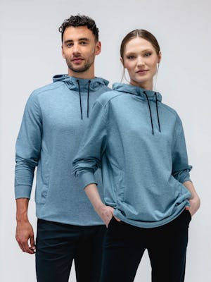 male and female models wearing lunar blue fusion terry for all hoodie facing forward with sleeves pulled up