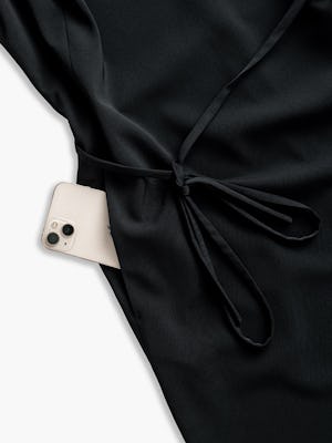 women's black swift sheath dress close up of phone sticking out of pocket