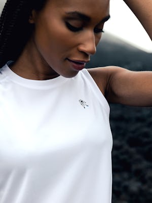 model wearing womens apoolo x active tank white limited edition zoom looking down at astronaut logo europe photoshoot