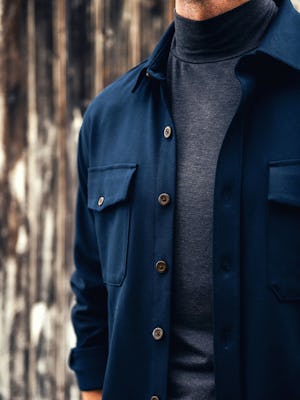 model wearing mens fusion overshirt navy ar8 and composite merino mock neck zoom buttons shot