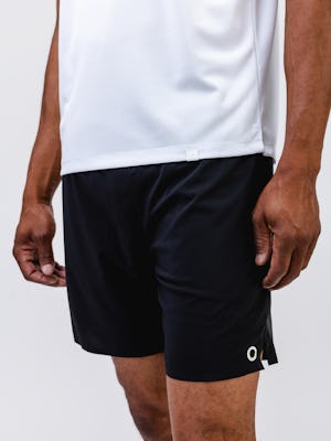model wearing mens apollo x active tee white and mens newton active short black zoom in on shorts