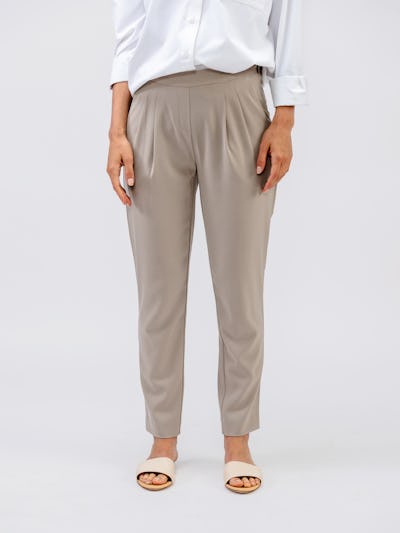 model wearing womens swift drape pant taupe and womens aero zero oversized shirt white waist down shot front standing arms by side