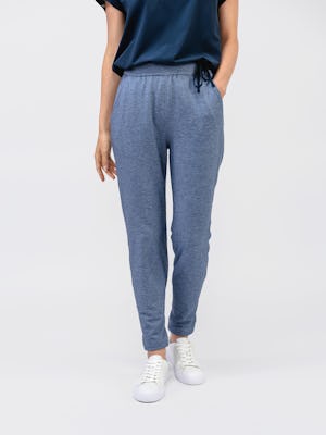 model wearing women's indigo heather fusion terry jogger waist down front shot one hand in pocket
