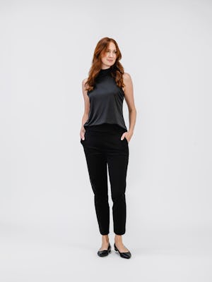 model wearing womens luxe touch mock neck black and womens kinetic twill 5 pocket pant black full body both hands in pocket