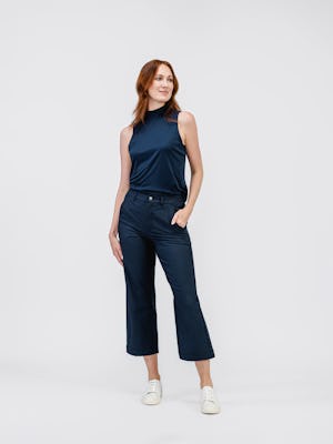 model wearing womens luxe touch mock neck navy and womens kinetic twill 5 pocket pant steel blue heather full body one hand in pocket