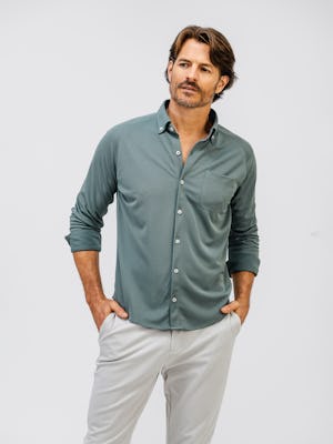 model wearing apollo raglan sport shirt calcium green and mens pace tapered chino light khaki both hands in pocket front shot