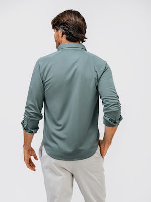 model wearing apollo raglan sport shirt calcium green and mens pace tapered chino light khaki one hand in pocket back shot