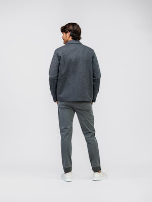 model wearing mens chore coat charcoal heather and mens composite merino long sleeve tee pale grey heather and mens fusion jogger slate grey full body back