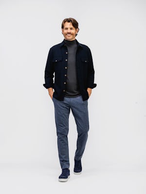 model wearing mens fusion overshirt navy and mens fusion jogger navy heather and mens composite merino mock enck charcoal heather full body both hands in pocket