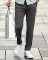 model wearing mens fusion jogger charcoal heather walking with mos shopping bag waist down