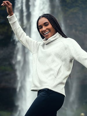 model wearing womens hybril fleece funnel neck soft marble waterfall behind lifestyle