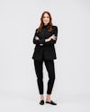 model wearing womens velocity oversized blazer black and womens luxe touch tee white and womens kinetic pull on pant black hands folder full body