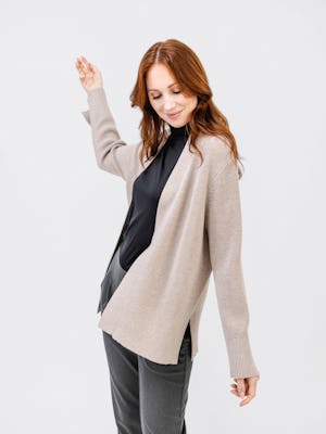 model wearing dwift drape pant charcoal heather and atlas cardigan oatmeal heather one hand in air